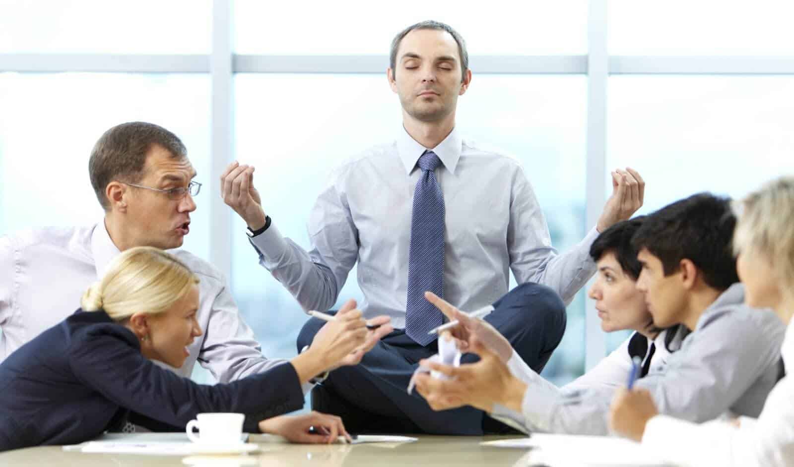 photo of employees arguing and bickering while one tries to stay calm