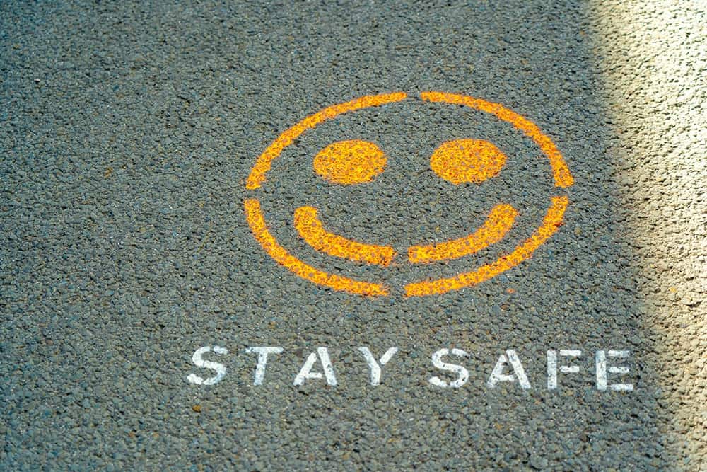 A Spray-painted reminder to "Stay Safe" at a corporate construction job site.