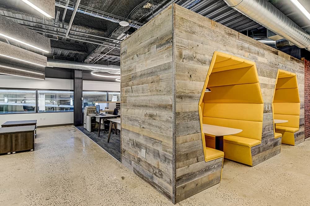 Trendy collaboration pods built to give workers a place to sit, chat, and work in a cozy environment