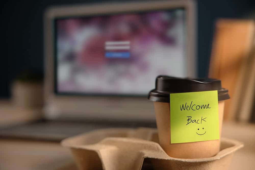 Coffee cup with a note that says "Welcome back"