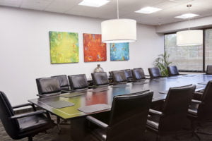 office conference room with leather seats and art on wall