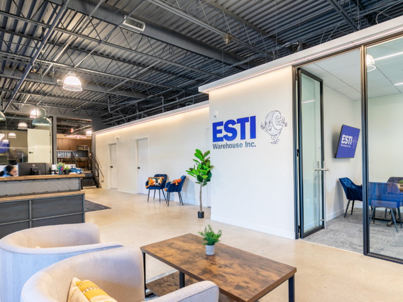 Photo of Completed Project for ESTI Warehouse featuring branded office color scheme, modern open-concept design, and collaboration areas