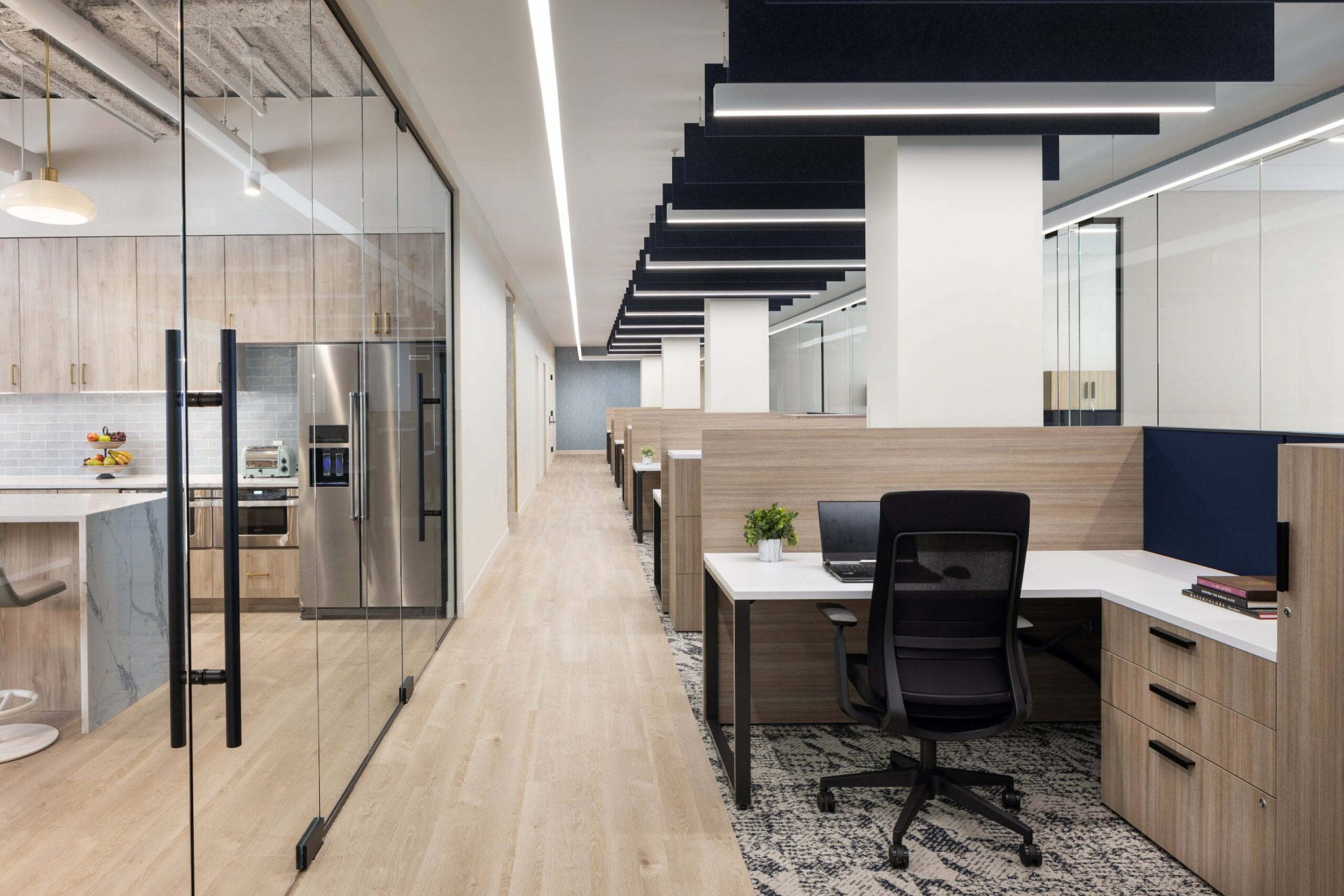 Office cubicles lined with glass partitioned offices