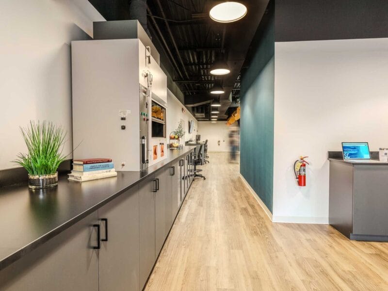 Renovated acoustics lab at Soundcoat redesigned by RI Workplace, featuring modern cabinetry, safety equipment, and a streamlined workspace layout for advanced product testing.