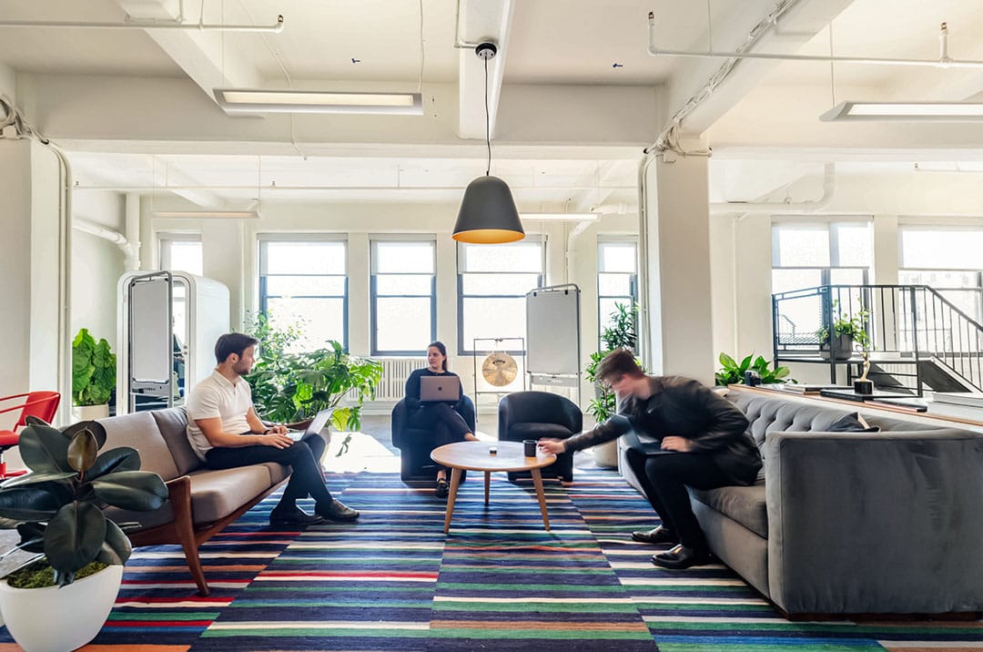 Casual meeting room with staff co-working in a comfortable lounge style environment