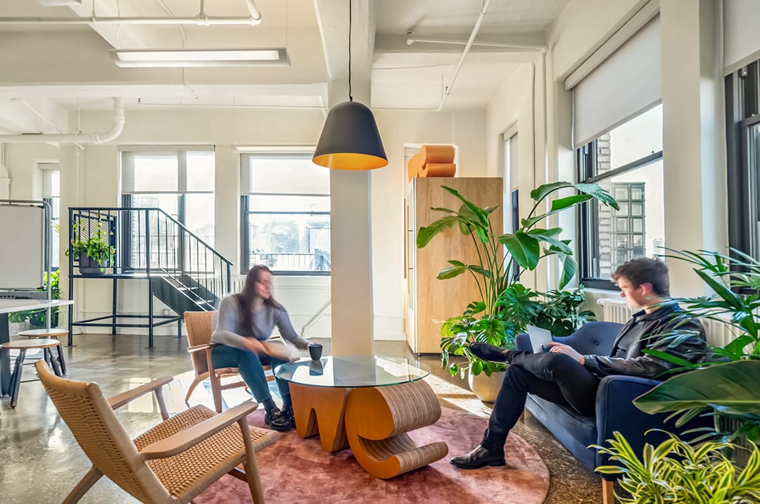 WeTransfer Head office lounge meeting space with staff co-working on laptops